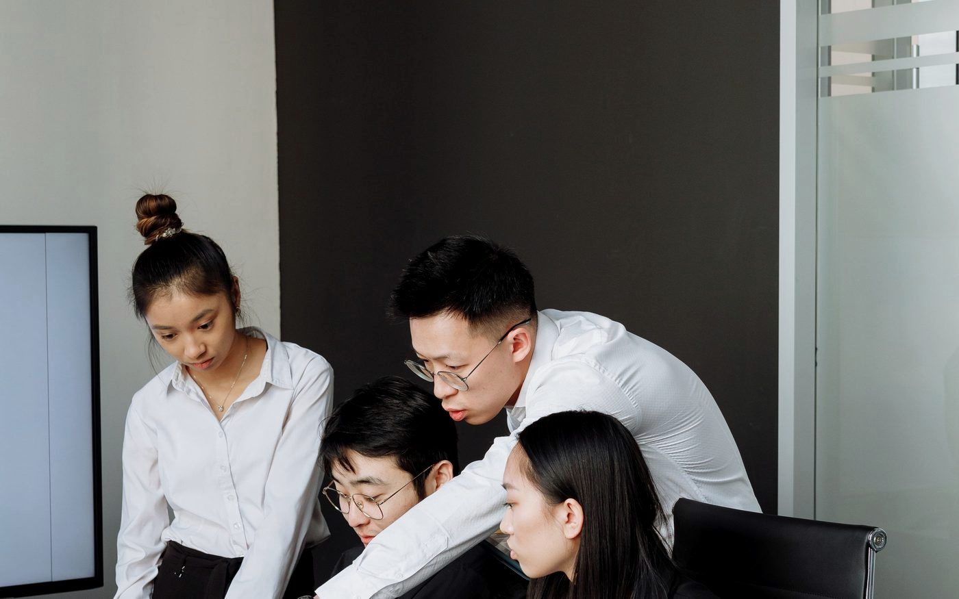 A team reviewing a company operating system rollout together